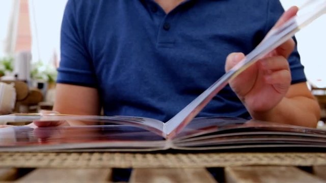 Male Hand Holding Restaurant Menu to Make Order for Lunch
