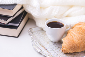 Coffee, plaid, croissant and books. Education concept.