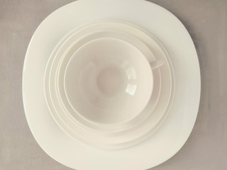 white dishes on a white background. white dishes on a light background. white dishes on a gray background. white dishes on a black background.