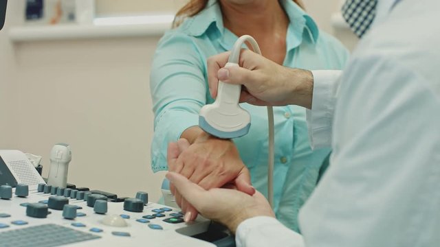 Woman Getting Wrist Ultrasound Scanning