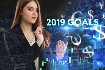 The concept of business, technology, the Internet and the network. A young entrepreneur working on a virtual screen of the future and sees the inscription: 2019 goals