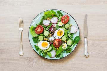 Fresh salad with vegetables and eggs for proper nutrition. Top view, copy space.