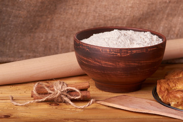 apricot pie and a bowl with flour and other ingredients and tools table