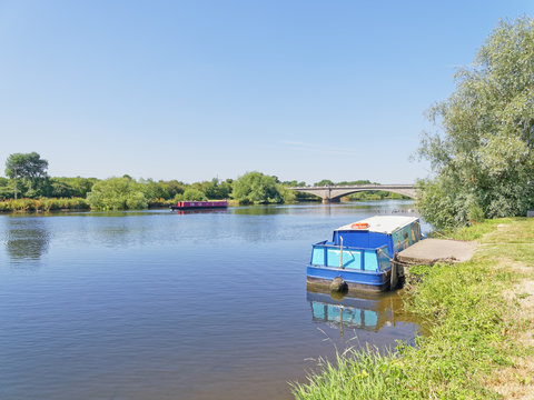 Barges moored on the banks of the River Trent close to Gunthorpe Bridge in Nottinghamshire.