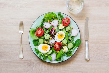 Fresh salad with vegetables and eggs for proper nutrition. Summer breakfast. Top view, copy space.