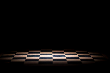 abstract chessboard on dark background lighted with snoot