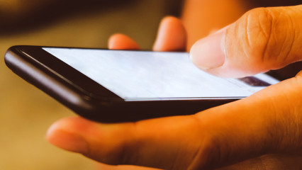 Close up of man's hands holding cell telephone