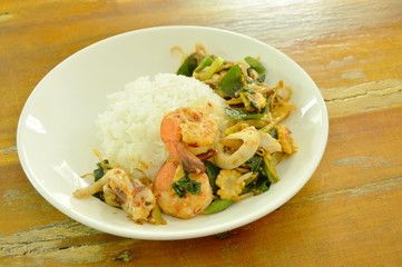 spicy fried shrimp and squid with herb on rice