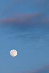 The full moon is shining brilliantly at night.