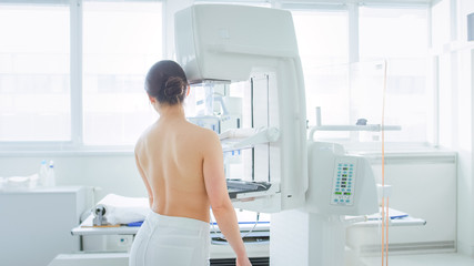 In the Hospital, Back View Shot of Topless Female Patient Undergoing Mammogram Screening Procedure....