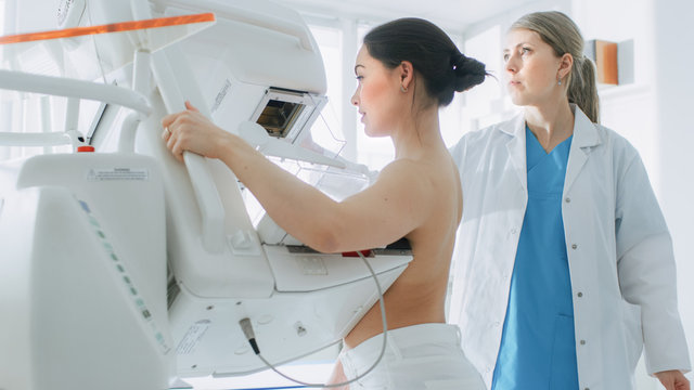 In The Hospital, Portrait Shot Of Topless Female Patient Undergoing Mammogram Screening Procedure. Healthy Young Female Does Cancer Preventive Mammography Scan. Modern Hospital.