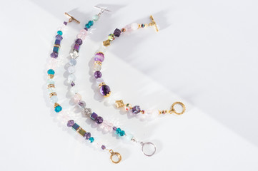 gold jewerly braslete with semiprecious at white background