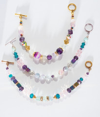 gold jewerly braslete with semiprecious at white background