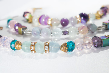 gold jewerly braslete with semiprecious at white background