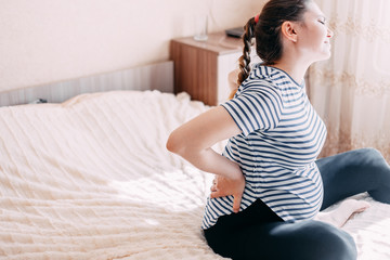 Pregnant woman having back aches, pain