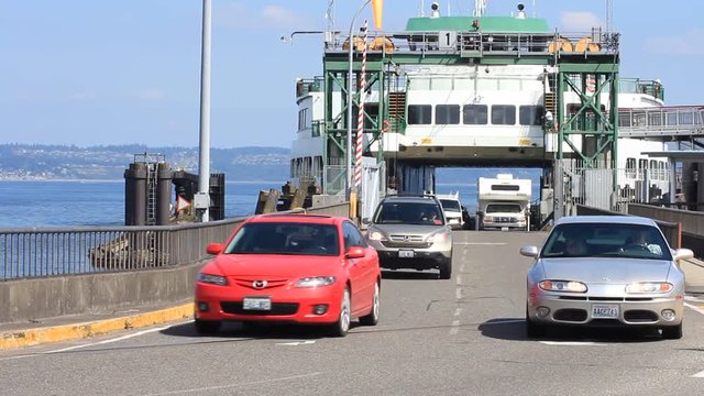 Pan of vehicles leaving the ferry.