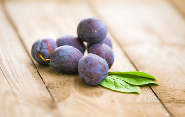 Organic plums on rustic background
