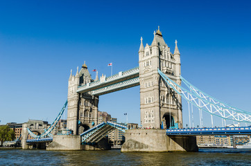 Fototapeta na wymiar Tower bridge raised England flags