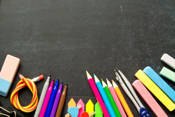 School supplies on blackboard background . The concept of education, study, learning, elearning. Back to school