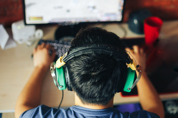 young man playing game on computer