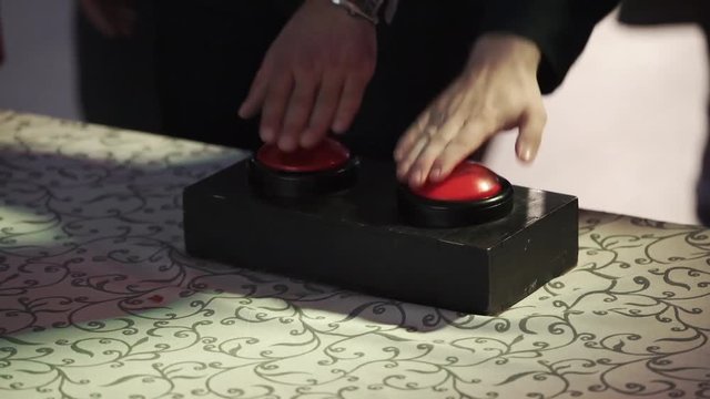 People pushing the red buttons in game