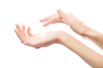 Cream on a woman's hand. Isolated against background