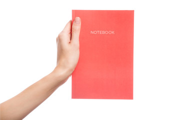 Hand holds a book on white isolated background. Space