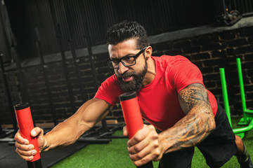 Strong sportsman during sled push exercise