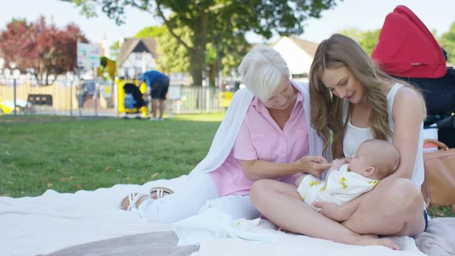 Mother and daughter with grandchild in a park