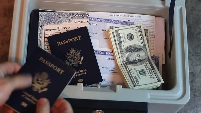 A small fire safe lock box is opened and some cash and a passport is returned.