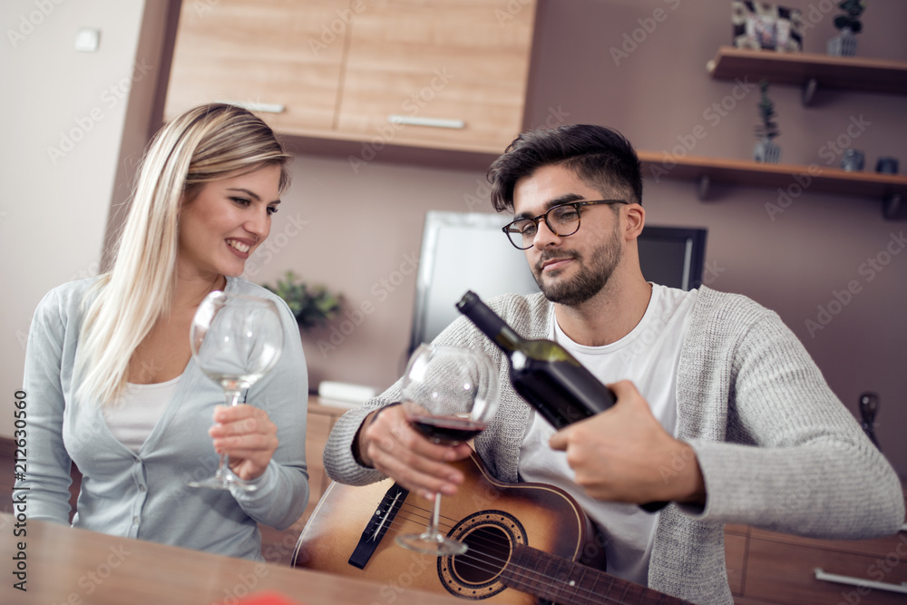 Poster happy lovely couple drink red wine.