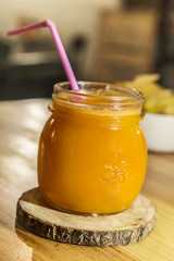 Retro glass jar of detox orange, carriot and turmeric juice.
