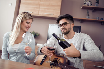 Happy lovely couple drink red wine.