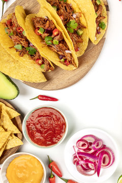 Overhead photo of Mexican tacos on white with salsa and copy space