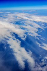 Aerial view of a cloudy daylight while flying above the clouds