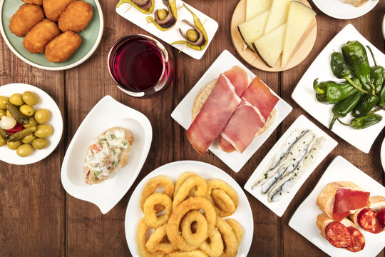 Spanish food. Overhead closeup photo of various tapas with wine, with copy space