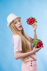 Young woman holding radish