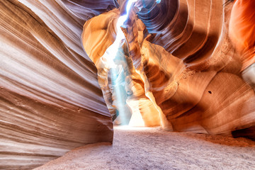 Upper Antelope Canyon with light rays filtering through sand dust