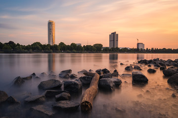 Long Exposure of the Skyscrapers of Bonn City at sunset and the river Rhine - obrazy, fototapety, plakaty