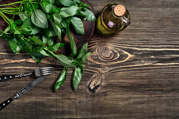 Green and purple fresh basil on wooden background. Top view