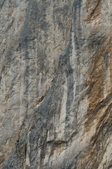 Sheer granite cliff /  	Sheer granite cliff in rocky mountains