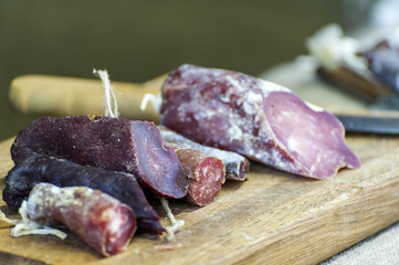 Wooden cutting board with salami