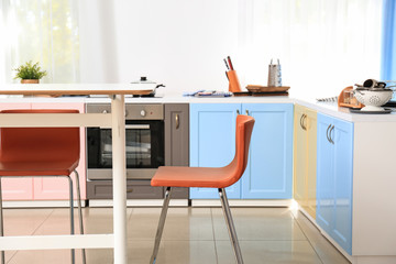 Bright modern kitchen interior with table and chair