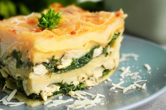 Piece of tasty spinach lasagna on plate, closeup