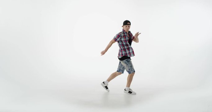 Young guy in casual dress dancing break.