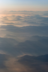 Mountains in the clouds hit by light rays
