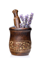 Wooden mortar with lavender flowers isolated on white background