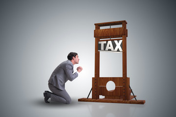 Businessman in heavy high taxes business concept