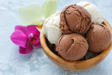 Homemade vanilla and chocolate sundae in a wooden bowl.