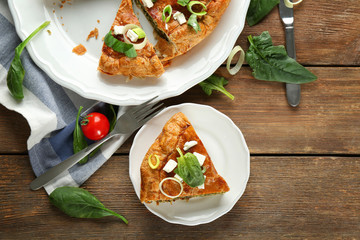 Tasty pie with spinach on table